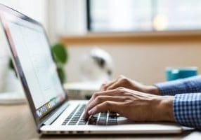 hands-typing-on-laptop